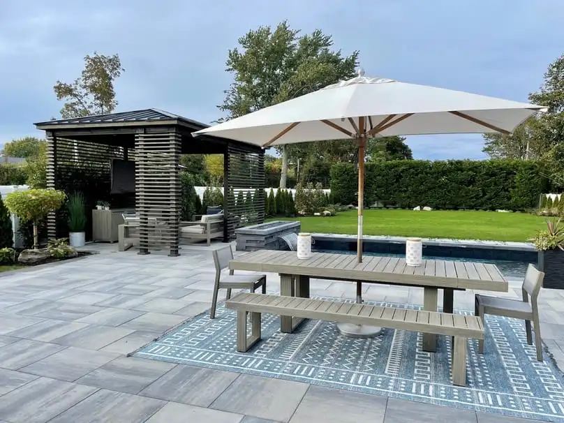 An elegant outdoor dining set including a large, white how to clean patio umbrella area.