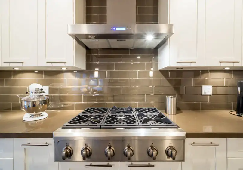 A clean kitchen with a stainless steel stove, for how to clean stainless steel appliances.
