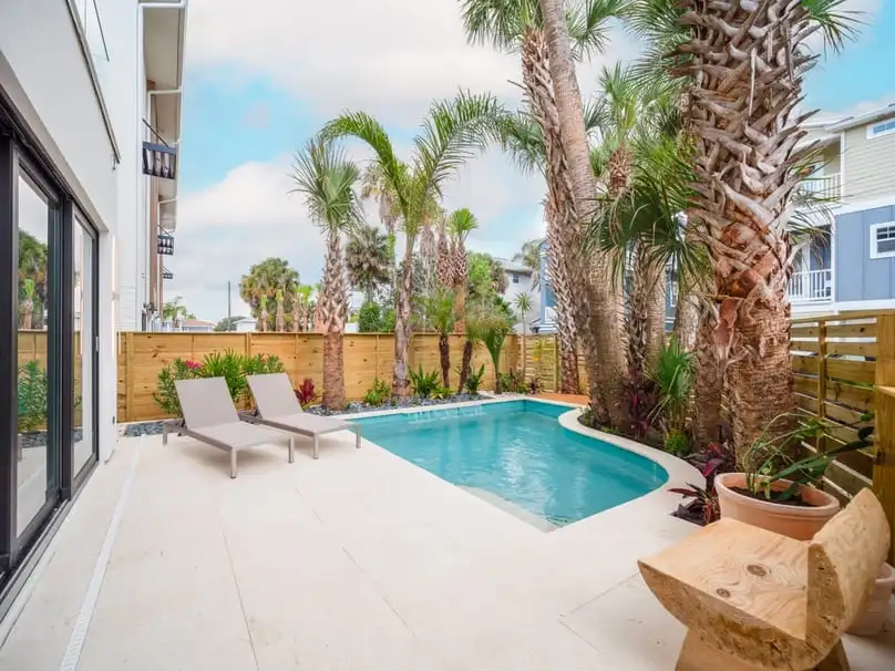 Poolside view of a house, a typical rental property in Florida. Here's how much does Airbnb take.