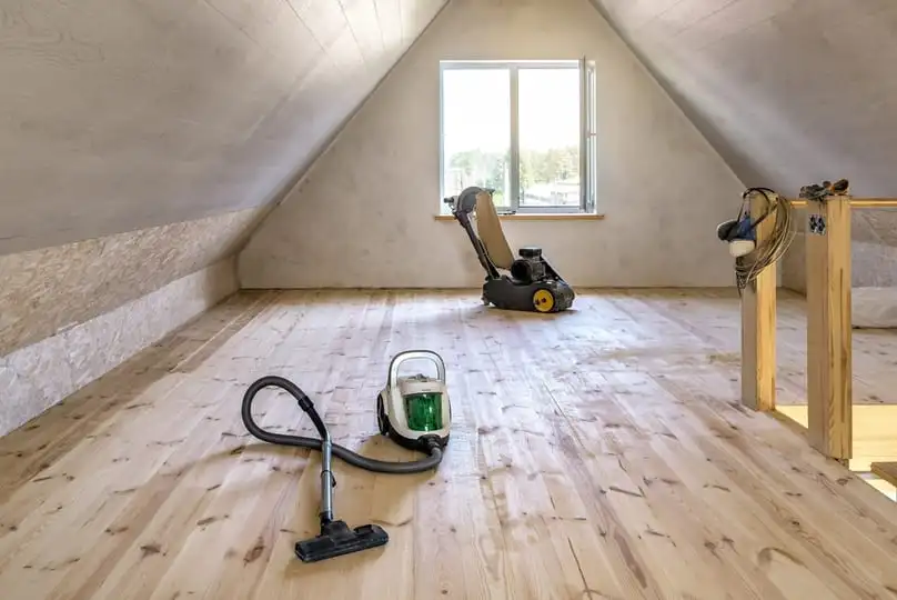 Clean wooden attic floor with a vacuum and polisher, showing how to clean floors after construction