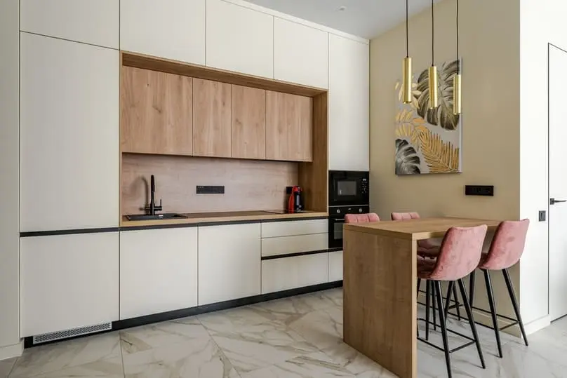 A modern kitchen with white and wood cabinets, inspiring ideas for how to clean kitchen cupboards.